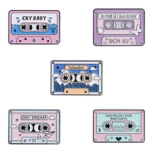 Set of five retro colorful enamel cassette tape badges with creative music slogans