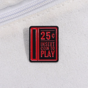 Detail of red and black retro arcade enamel pin featuring 25 cent coin insert design