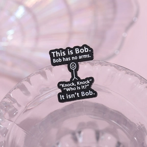 Funny Bob stickman enamel pin with humor quote on polished black badge surface