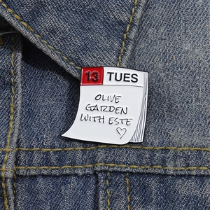 Taylor Swift inspired Olive Garden enamel brooch featuring 13 Tuesday calendar design