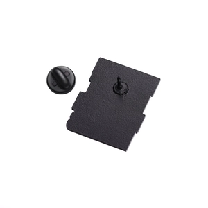Macro shot of black enamel lapel pin back showing rubber clutch and metal texture