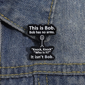 Funny This is Bob stickman enamel pin on denim jacket showing minimalist geometric design