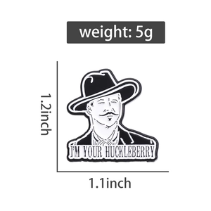 Close-up of vintage enamel pin with 'I'M YOUR HUCKLEBERRY' text and portrait, 1.2x1.1 inches
