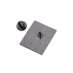 Detail of the black matte metal pin back and soft rubber clutch closure for brooches