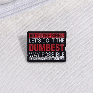 Detail of enamel pin with sarcastic text on white canvas background showing fine texture