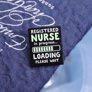 Black enamel Registered Nurse brooch with loading bar design on blue textured background