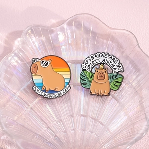 Creative Capybara enamel pin set with Don't Worry Be Capy and Spirit Animal slogans