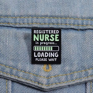 Funny black enamel pin showing Registered Nurse in progress loading bar on denim jacket