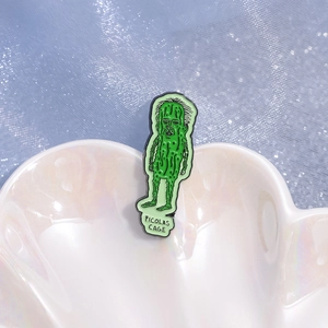 Green Picolas Cage pickle enamel pin made of zinc alloy on a white shell tray