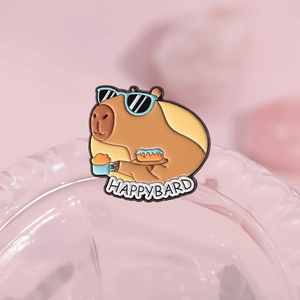 Cute cartoon capybara enamel pin with sunglasses and HAPPYBARD text on a pink background