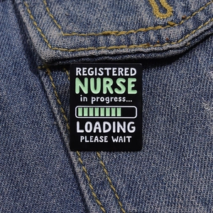 Detail of Registered Nurse loading progress bar enamel pin on blue denim jacket