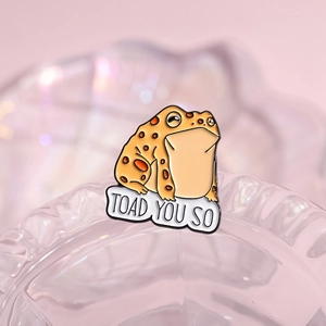 Funny cartoon orange spotted toad enamel pin with Toad You So text on crystal base