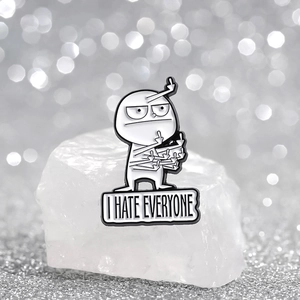 Funny 'I Hate Everyone' enamel pin with cartoon multi-hand gesture on white rock