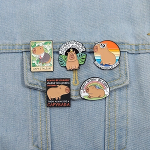 Cute capybara enamel pin set on denim jacket with colorful animal designs and slogans