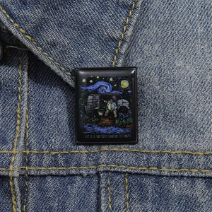 Artistic rectangular enamel pin with Starry Night design pinned on a denim jacket