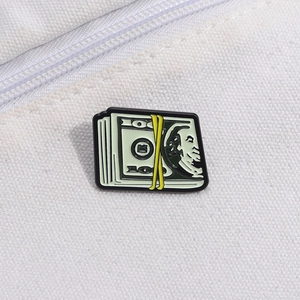 Detail of creative dollar bill enamel pin with 100 face value on white canvas background