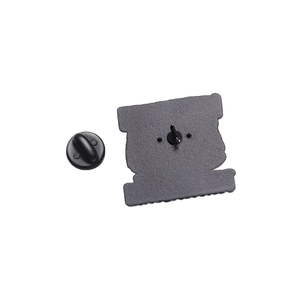 Detail of the black metal backplate and matching rubber clutch for enamel brooch pin