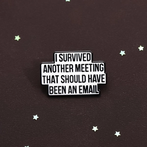 Macro detail of enamel lapel pin with funny office quote on brown textured background