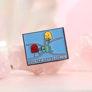Cartoon electricity explained enamel pin with Volt Amp and Ohm icons on pink crystal
