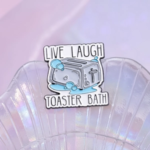 Creative enamel pin featuring a toaster bath design with Live Laugh Toaster Bath text