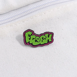 Graffiti style FRESH enamel pin with green and pink colors on white canvas background