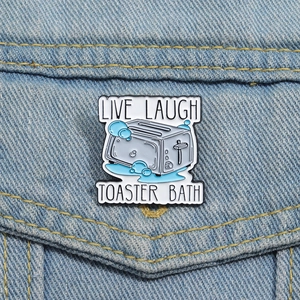 Funny pop art toaster bath enamel pin badge with letters on a denim jacket pocket