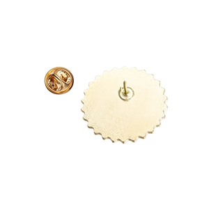 Detail view of the back of a gold brooch with butterfly clutch and gear-shaped metal pin