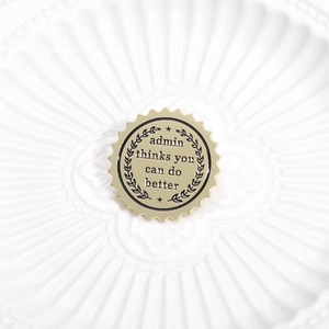 Golden badge brooch with Admin Thinks You Can Do Better text and laurel wreath