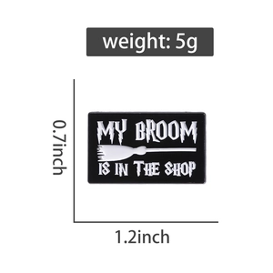 Detail view of rectangular black enamel pin with dimensions and weight measurement