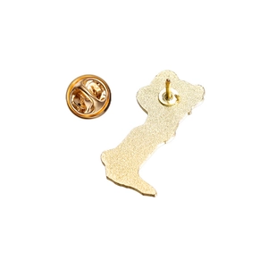Detail of gold enamel pin back with textured metal finish and butterfly clutch closure