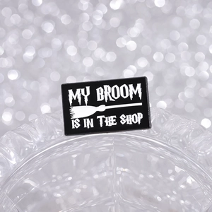 Funny black and white enamel broom pin with My Broom is in the Shop message