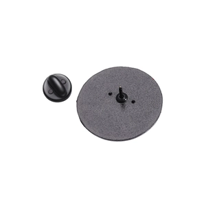 Close-up of the metal pin base and black rubber butterfly clasp on a matte badge