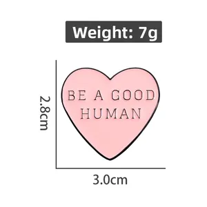 Pink heart enamel pin with Be A Good Human slogan for clothing accessories
