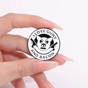 Round enamel pin featuring I Love Guns and Bacon text with cartoon pig and guns