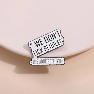 Detail shot of the black and white enamel pin featuring humorous English quote slogans