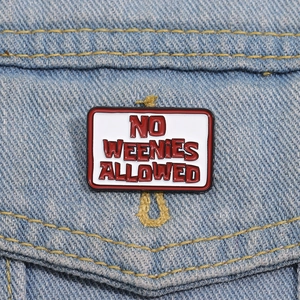Rectangle enamel pin with 'NO WEENIES ALLOWED' text on blue denim jacket pocket