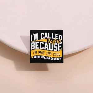 Creative black square enamel pin with funny English text on a minimalist ceramic tray