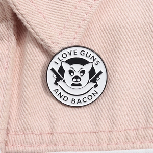 Enamel pig badge with I Love Guns And Bacon text on pink denim jacket collar