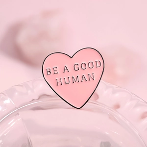 Pink heart enamel pin with 'BE A GOOD HUMAN' quote for garment decoration