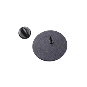 Close-up of matte black rubber pin backings and metal butterfly clutches for brooches