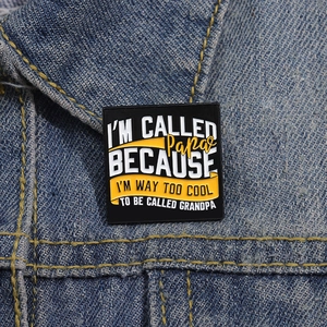 Funny square enamel pin with father and grandfather quote on denim jacket fabric