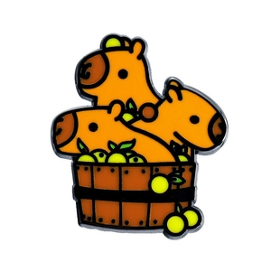 Cute cartoon capybara enamel pin set featuring three orange animals in a brown wooden barrel