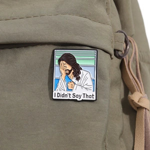Detail of I Didn't Say That Jesus enamel pin attached to an olive green canvas bag