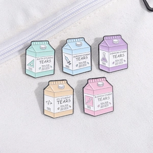 Five unique milk carton enamel pins for students featuring various academic majors
