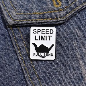 Black and white Speed Limit Full Send enamel pin featuring a Shaka sign on denim