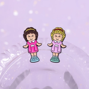 Cartoon curly hair girl enamel pin set with pink and lavender dresses on glass edge
