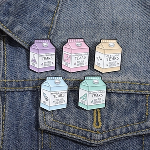 Set of five creative milk carton enamel pins featuring academic major themed icons