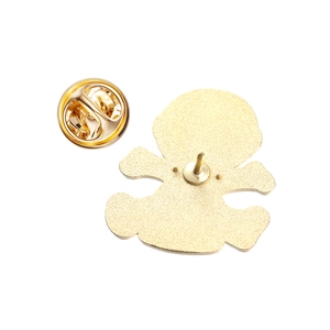 Close-up of golden metal enamel pin back with classic butterfly clutch and textured finish
