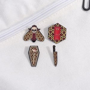 Set of 4 horror movie enamel pins featuring 237 room key and skull moth on canvas