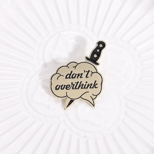 Retro cloud badge with sword design and 'Don't Overthink' text on a white textured dish